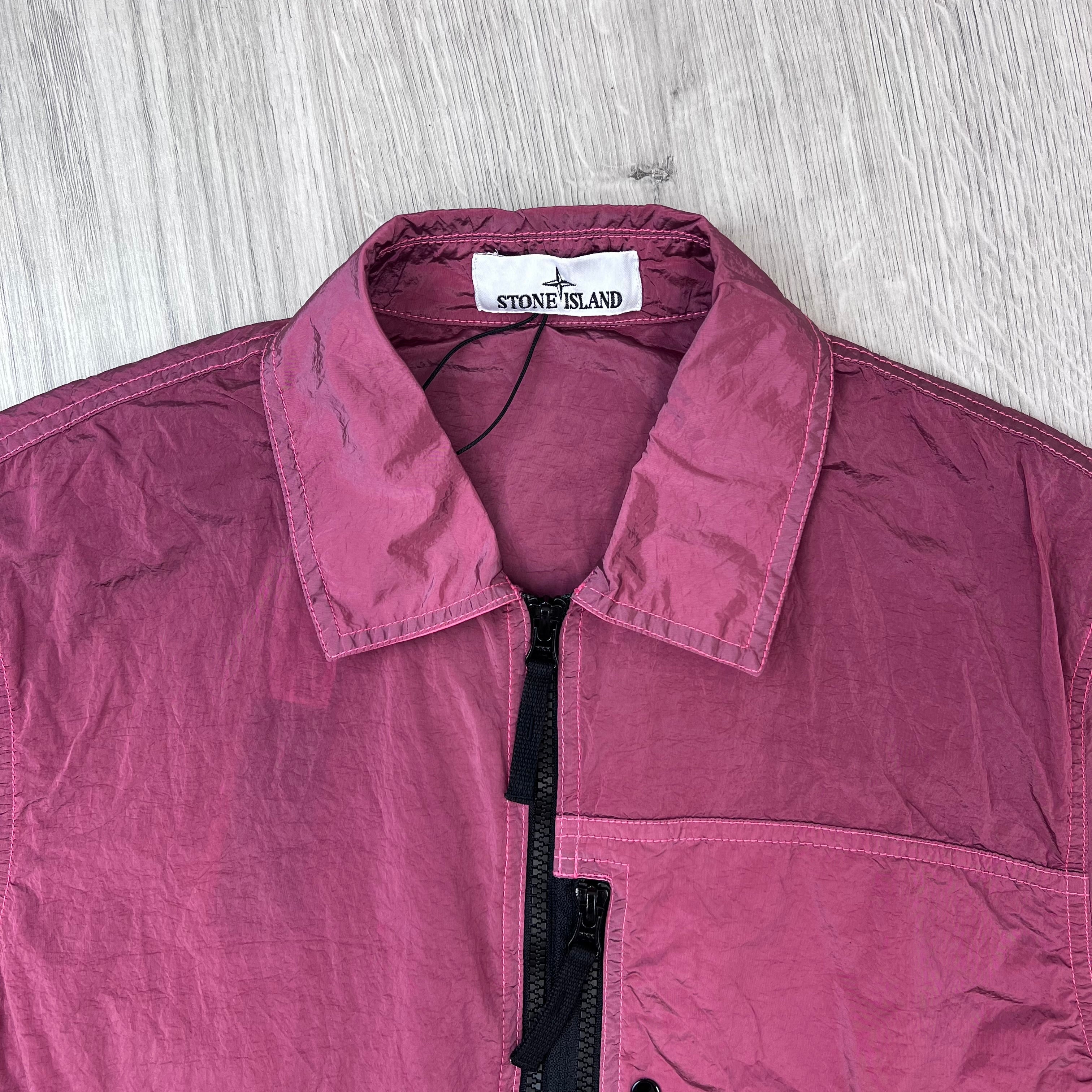 A close up view of the classic collar and neck label on a Stone Island Nylon Metal Overshirt in Geranium.