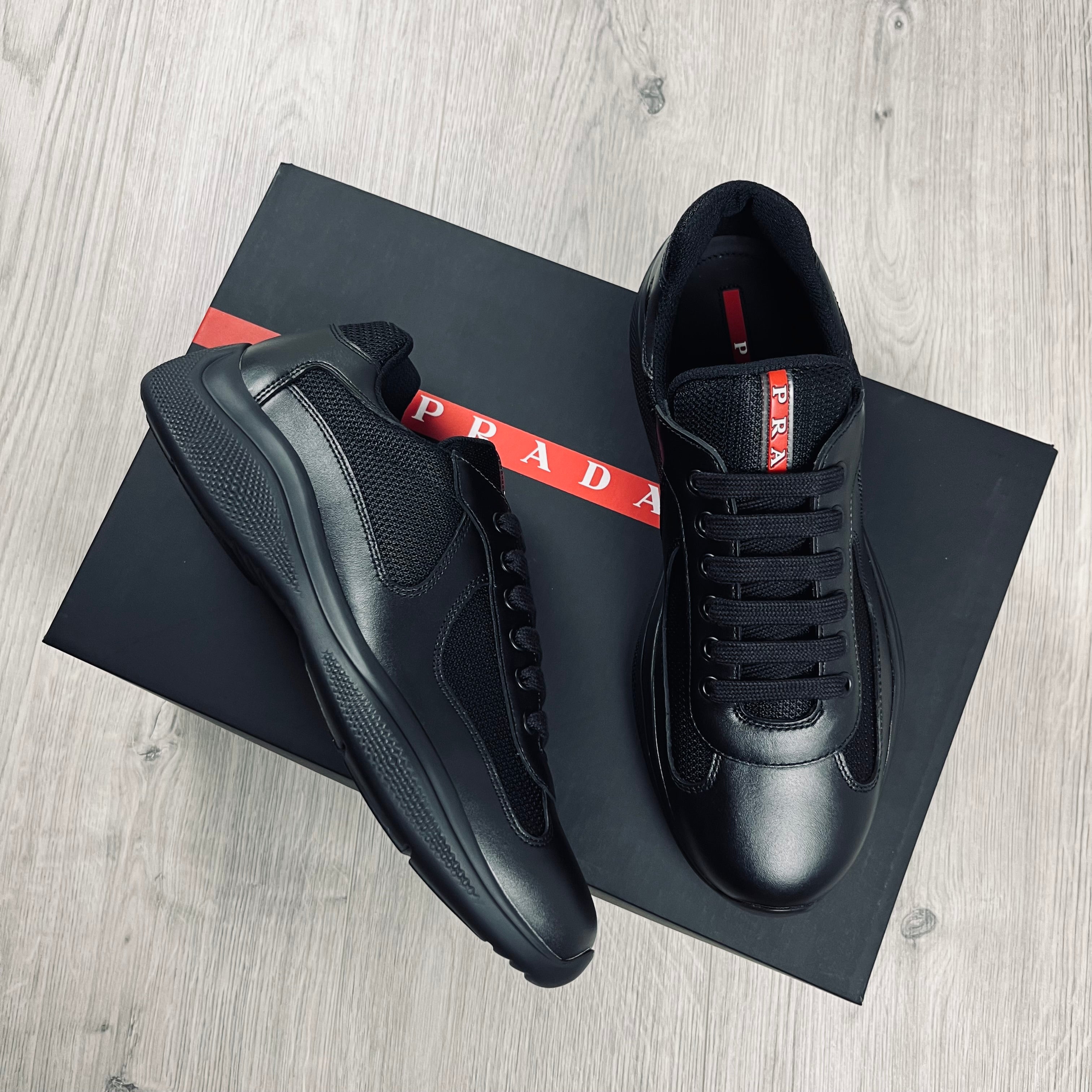 Prada Americas Cup Sneakers in Black. On sale at Open Attire