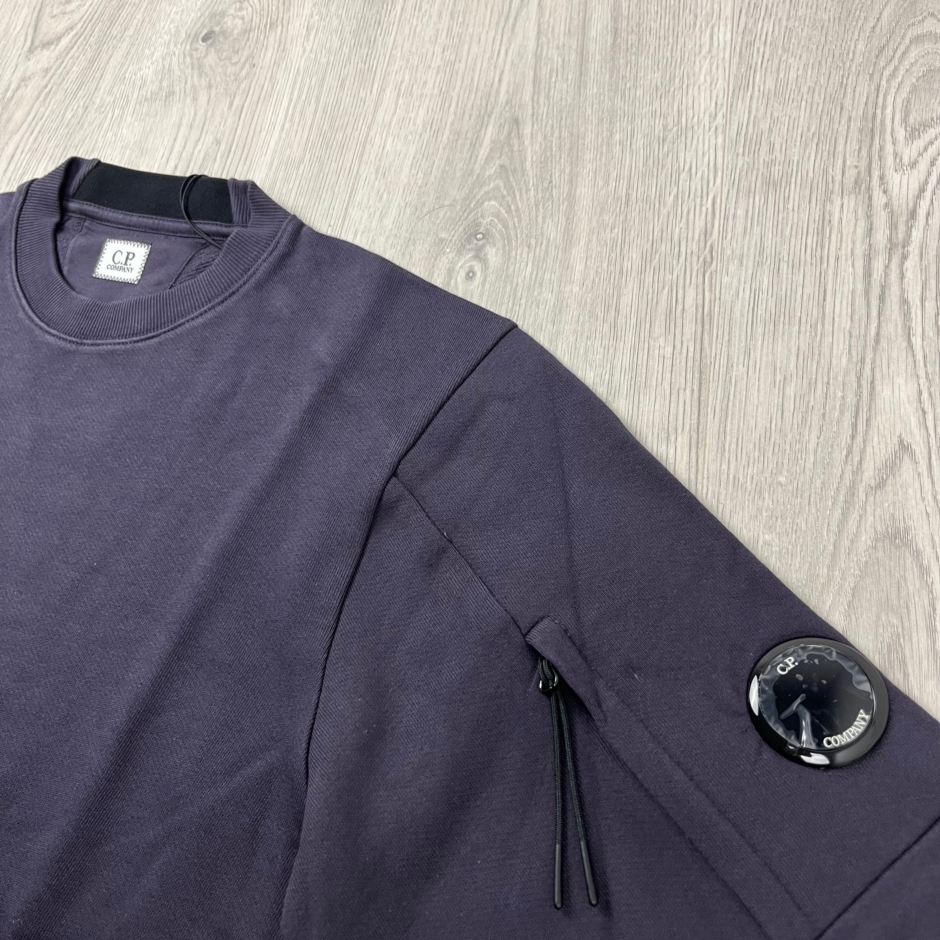 CP Company Diagonal Raised Fleece Crew Neck Lens Sweatshirt in Nightshade Purple. On sale at Open Attire.